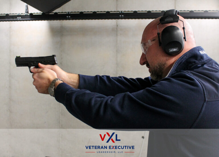 A man is holding a gun aimed at a target.